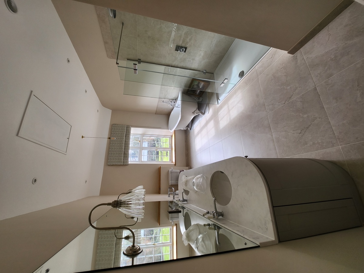 Luxury bathroom with tiled walls and painted finishes