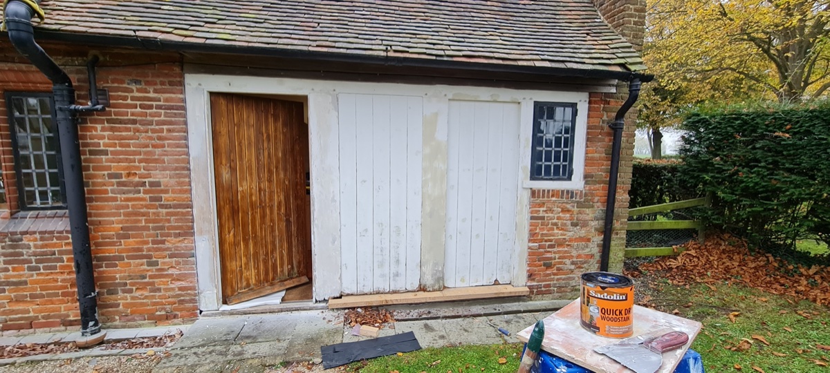 Garage exterior before painting — weathered and peeling