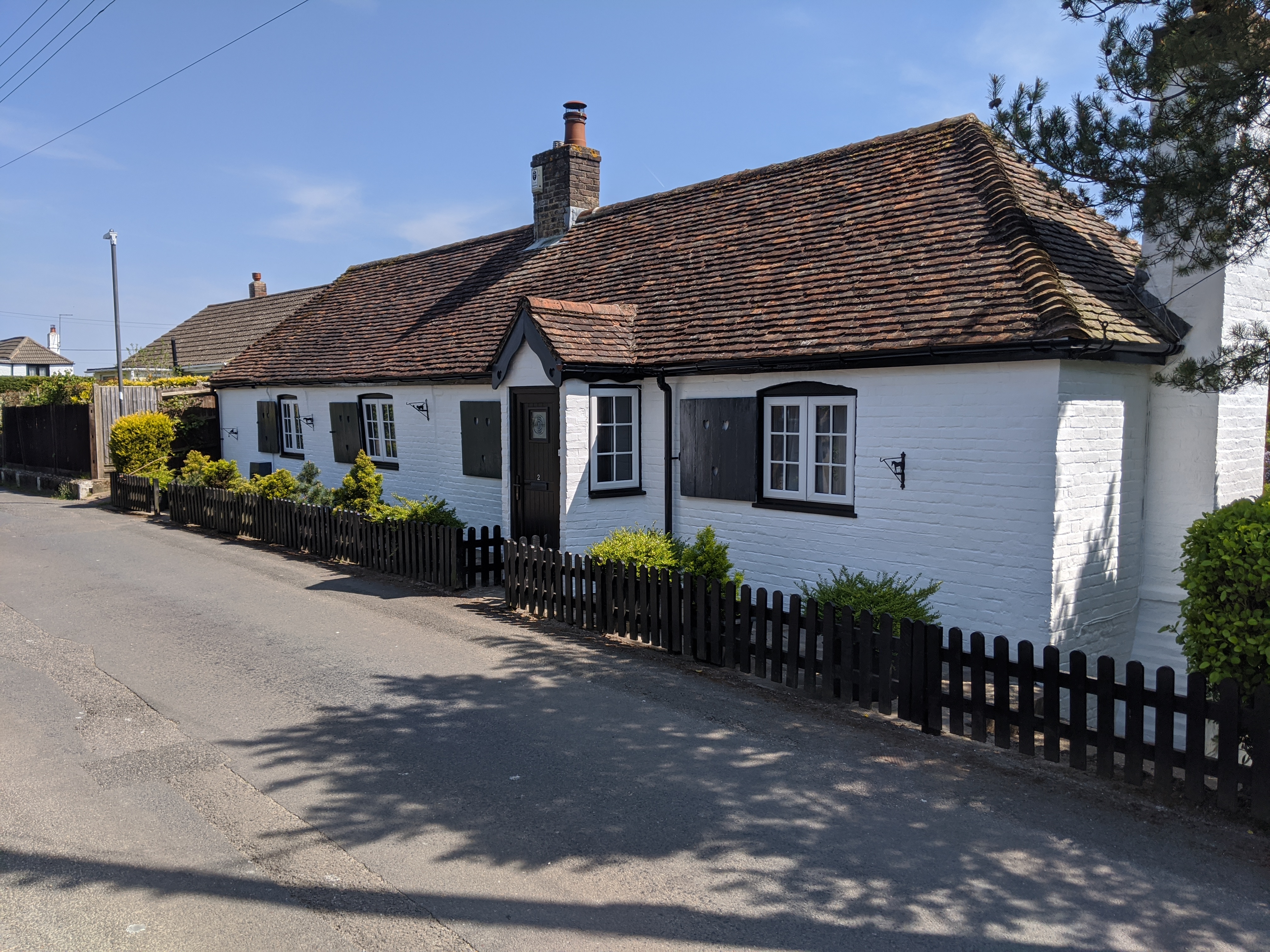 Cottage exterior after rendering and painting — clean fresh finish