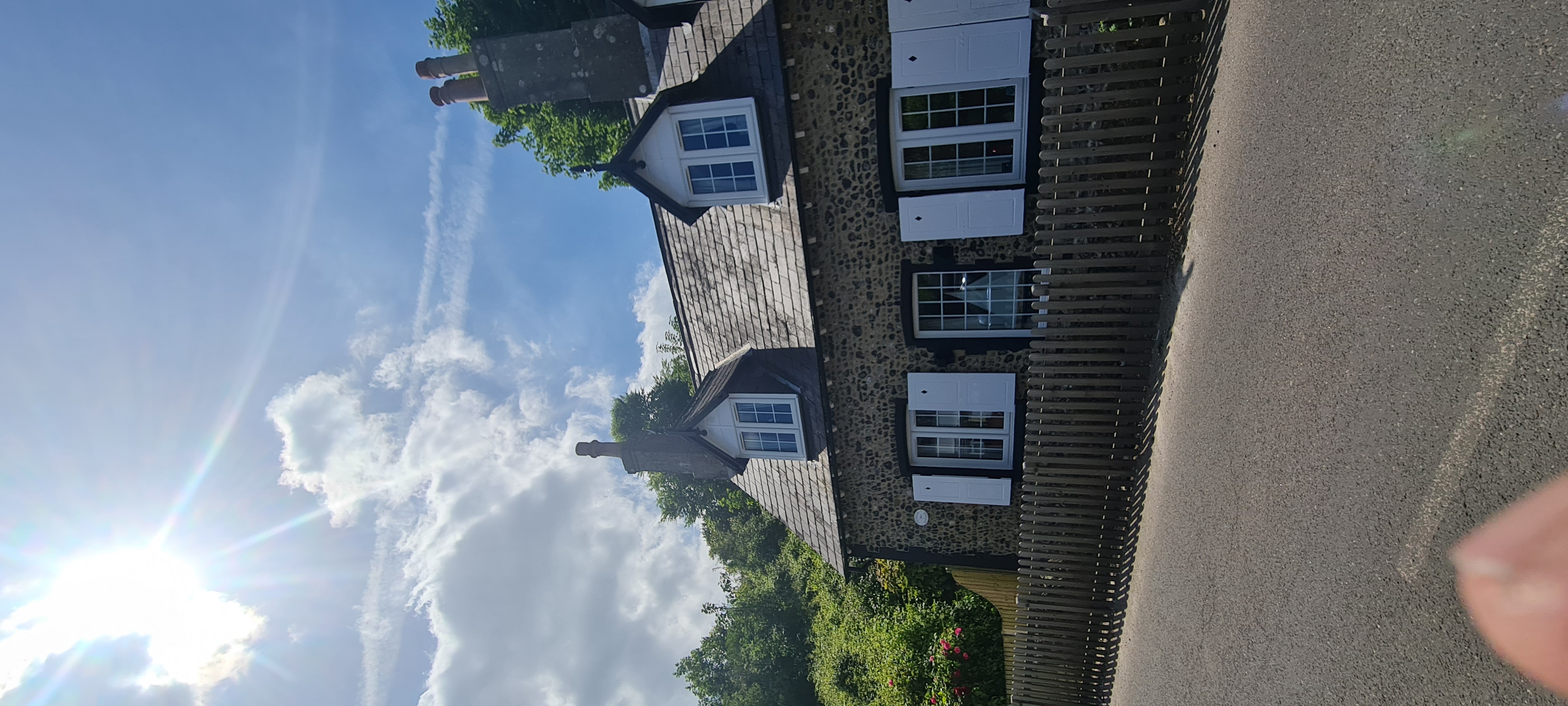 Cream painted country building with flint details and white framed windows