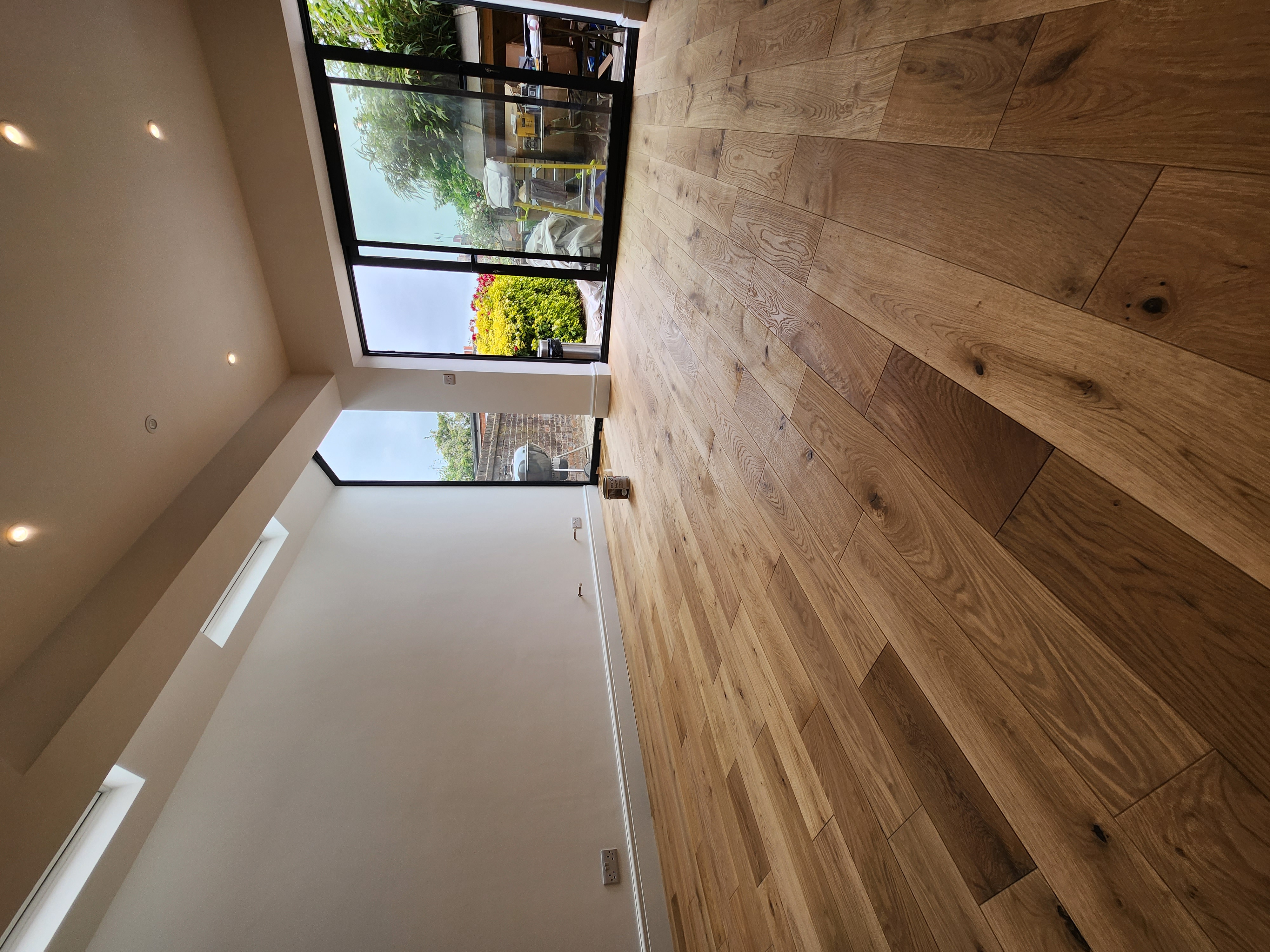 Modern extension interior with oak floor, skylights and bi-fold garden doors