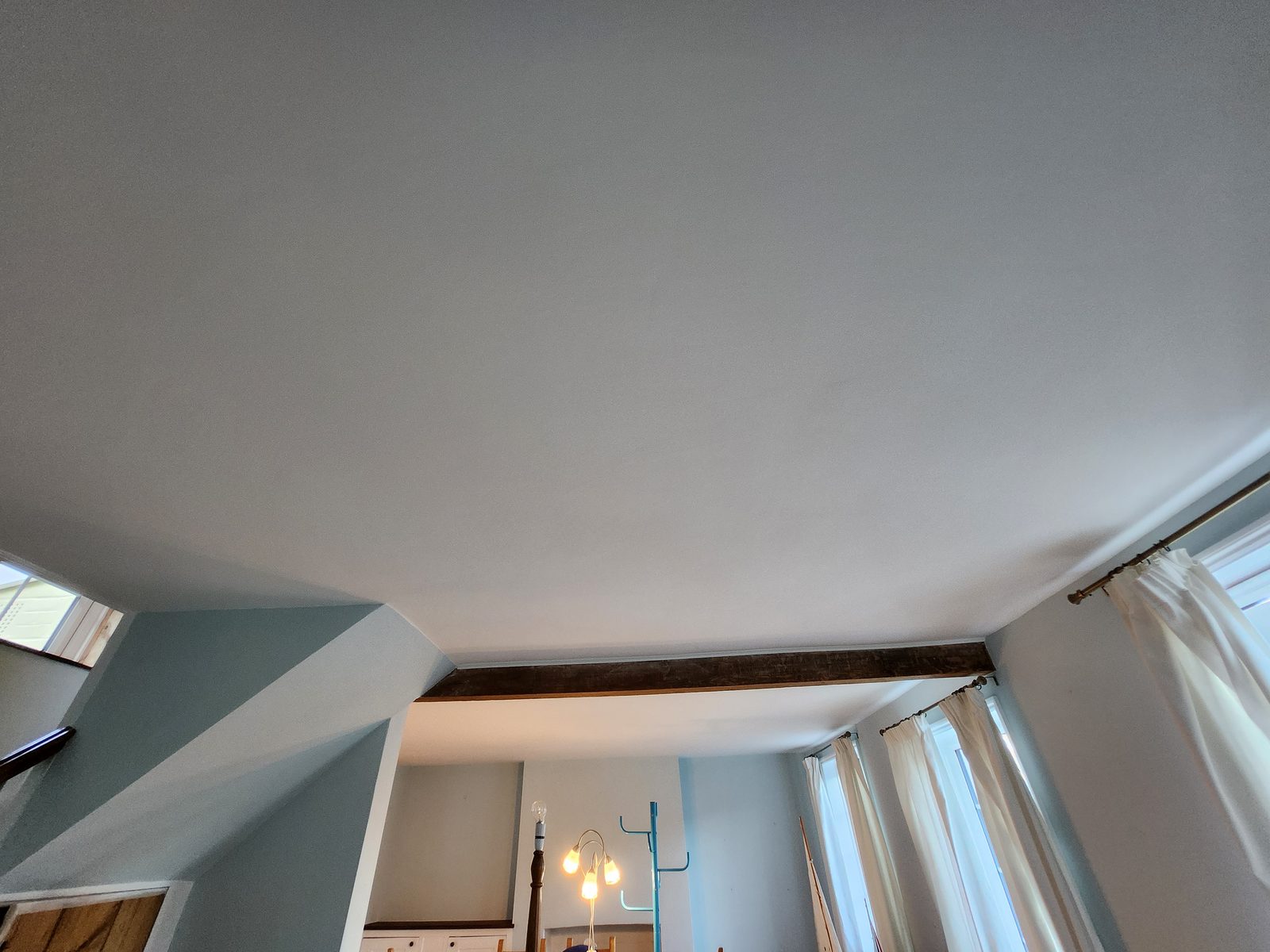 Room with blue-grey walls and angled vaulted ceiling