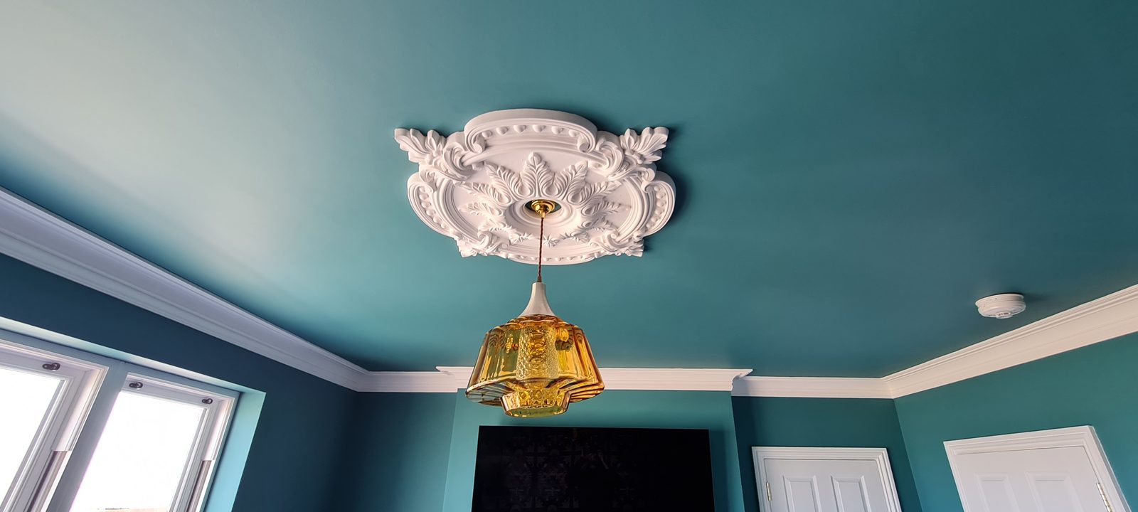 Teal ceiling with ornate plaster rose