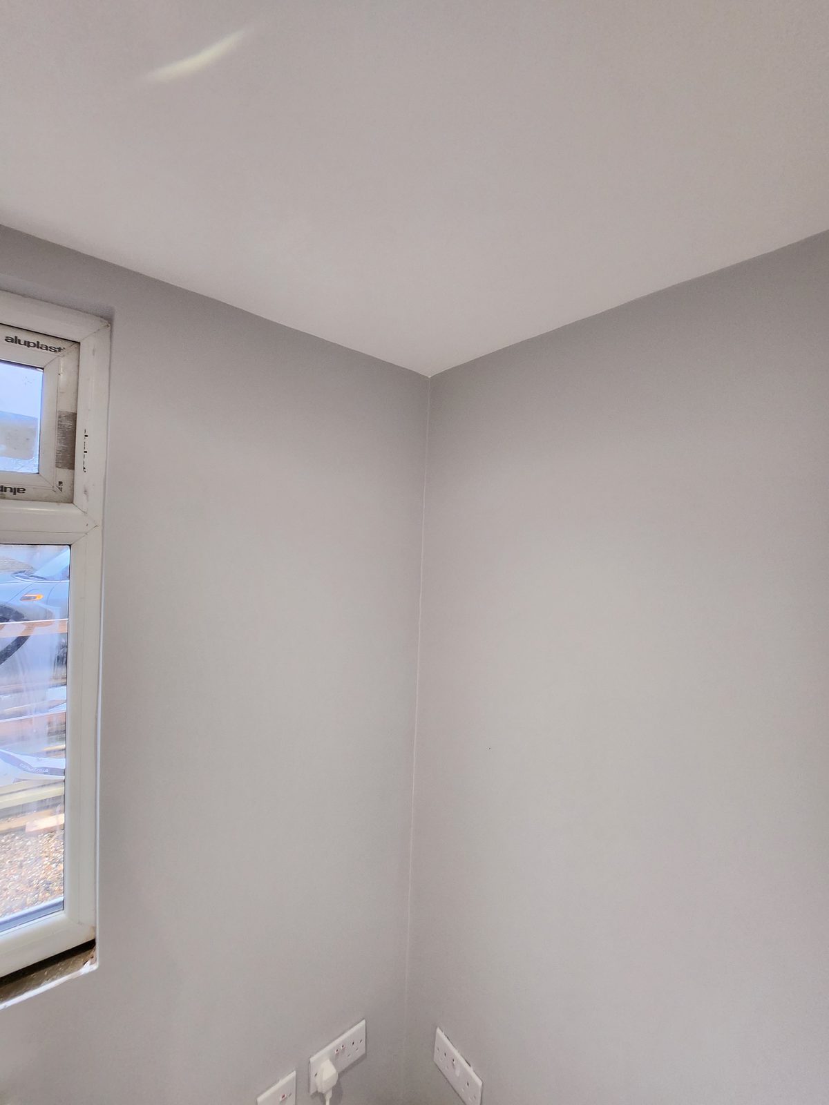 Precision cutting-in on grey painted walls