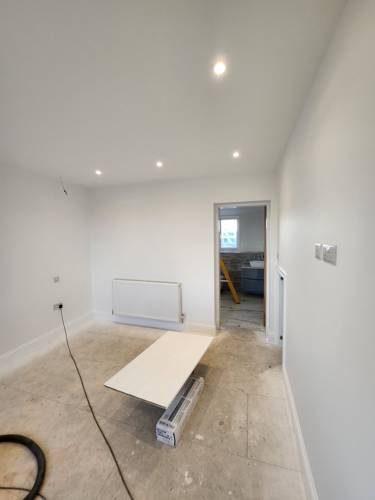 Freshly decorated bright white room with recessed lighting